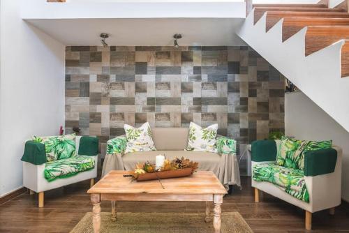 a living room with a couch and two chairs and a table at La Casita de Coco Tejeda in Tejeda