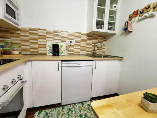a kitchen with white cabinets and a counter top at La Casita de Coco Tejeda in Tejeda