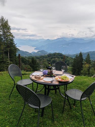 a table with a plate of food and wine glasses at Villa Chalet Bellagio Panorama in Bellagio