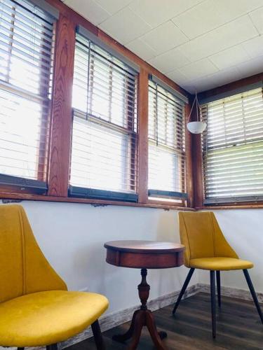 two chairs and a table in a room with windows at Overlook Too! at Lake Koshkonong in Milton