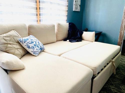 a white couch with pillows on it in a room at Overlook Too! at Lake Koshkonong in Milton