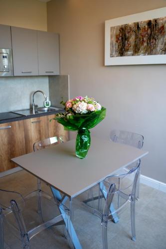 a vase of flowers sitting on a table in a kitchen at Freedom in SantʼAntonio Abate