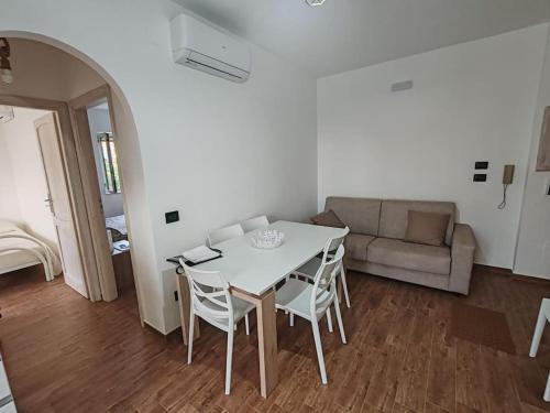 a living room with a table and chairs and a couch at Da Gioia e Fortunato casa vacanze in San Nicola Arcella