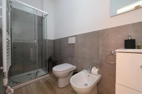 a bathroom with a toilet and a glass shower at Residence della Accademia in Modena