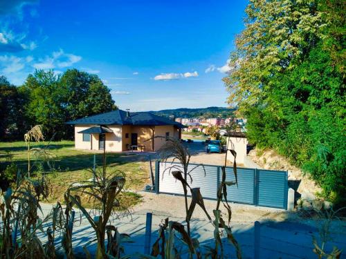 a house with a fence in front of a yard at Vikendica-Villa Belvedere Srebrenik in Srebrenik
