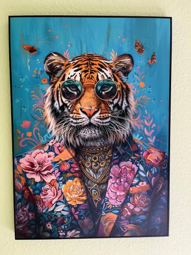 a painting of a tiger in a suit and glasses at Hotel Waldkur in Leer