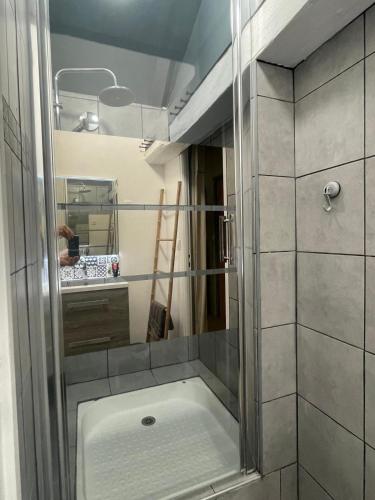 une douche avec une porte vitrée dans une salle de bain dans l'établissement chambre 4 personnes avec entrée indépendante , grand parking, salle de bain, wc, à Confolens