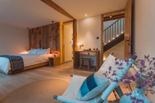 a bedroom with a bed and a chair in a room at Infini House in Dali