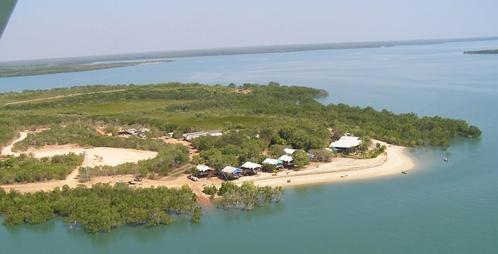 an island in the ocean with a group of tents at Crab Claw Island in Bynoe Harbour