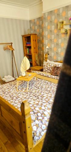 a room with a wooden bed with an umbrella at Home away from home in Aberdeen