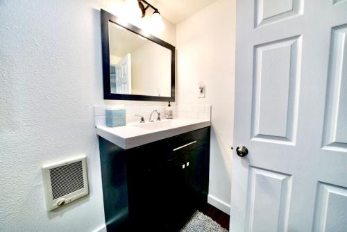 a bathroom with a sink and a mirror at 10 Bedroom Historical Downtown Albany Pet Friendly Home in Albany