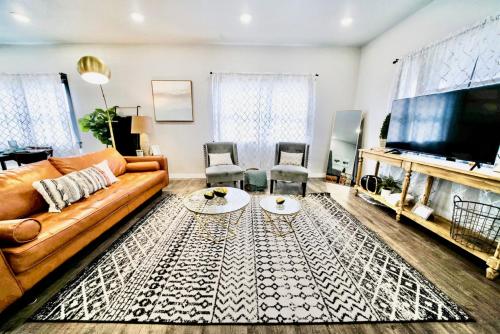 a living room with a couch and a flat screen tv at 10 Bedroom Historical Downtown Albany Pet Friendly Home in Albany