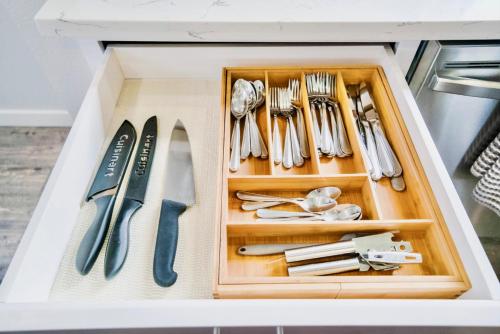 a drawer full of utensils in a white drawerlictsangering at 10 Bedroom Historical Downtown Albany Pet Friendly Home in Albany