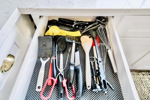 a drawer filled with spatulas and other kitchen utensils at 10 Bedroom Historical Downtown Albany Pet Friendly Home in Albany