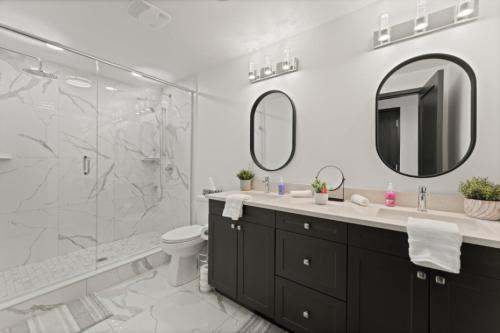 a bathroom with a shower and a toilet and a sink at Luxury 171-7 Condos with Magnificent Lakeviews in Leamington