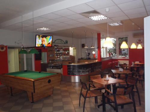 a restaurant with a pool table in the middle of the room at Zajazd Markowski in Bojanowo