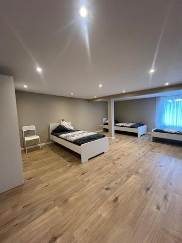 a large room with two beds and a window at Serena Monteur Apartment in Rodenbach