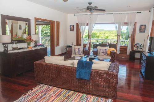 a living room with a couch and a television at Antigua 3-bedroom Villa at Nonsuch Bay in The Brook