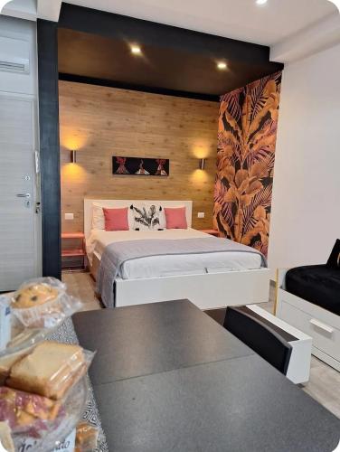 a bedroom with a bed and a table in it at Urban Home in Pompei