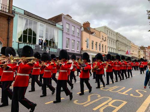 a marching band in red uniforms in a street at Spacious & light 2bed, 2bath in the heart of Windsor in Windsor