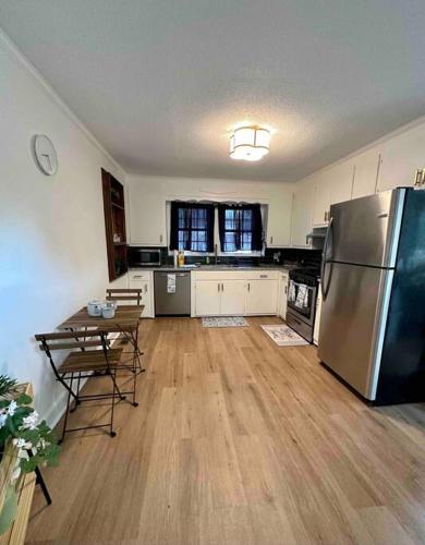 a kitchen with a stainless steel refrigerator and a table at Beautiful Contemporary 2BDR in Concord