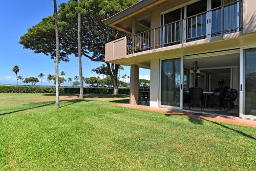 a house with large windows and a lawn at Maui Eldorado Condo J100 in Kaanapali