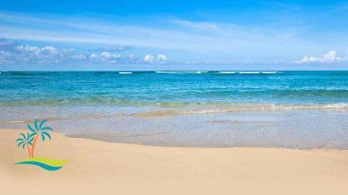 a beach with a palm tree in the sand at Maui Eldorado Condo J100 in Kaanapali