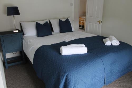 a bedroom with a large bed with towels on it at Shrewsbury Georgian town house - Hills Lane in Shrewsbury