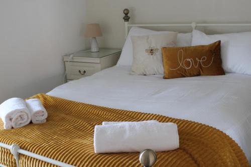 a bedroom with a bed with towels on it at Shrewsbury Georgian town house - Hills Lane in Shrewsbury