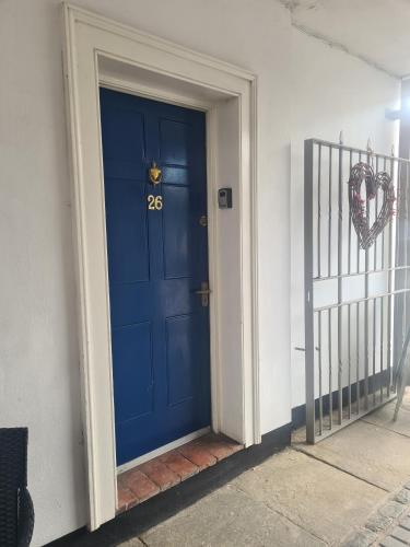 a blue door with a number on it next to a gate at Shrewsbury Georgian town house - Hills Lane in Shrewsbury