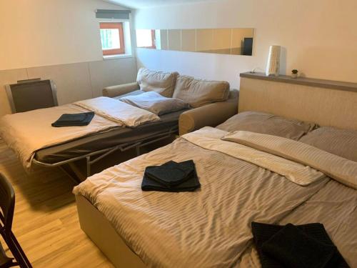 a room with two beds and a couch at Apartmán Stratos in Ostružná