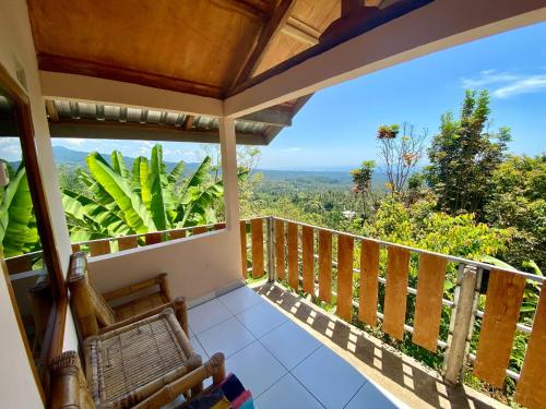 a balcony with a view of the jungle at Senaru sunset house in Senaru