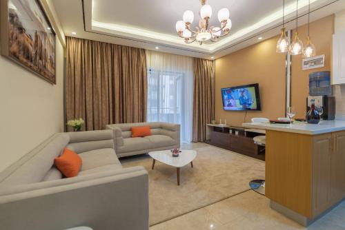 a living room with a couch and a table at Exquisite Condo with Free parking Gym and Pool in Nairobi