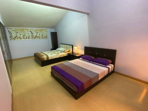 Ένα ή περισσότερα κρεβάτια σε δωμάτιο στο Mango Impian Homestay