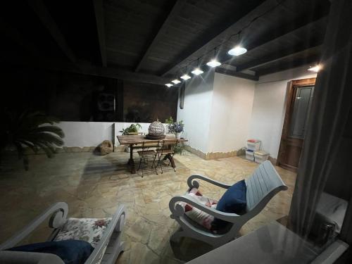 a living room with two chairs and a table at Luxury Pisu Apartments in Quartucciu