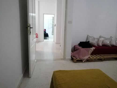 a white room with a bed and a hallway at Diyar LîLâ Selma in Tataouine
