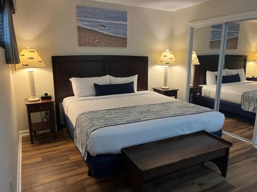 a bedroom with a large bed and two lamps at Summer Sands - 207 by Sea Scape Properties in Wrightsville Beach