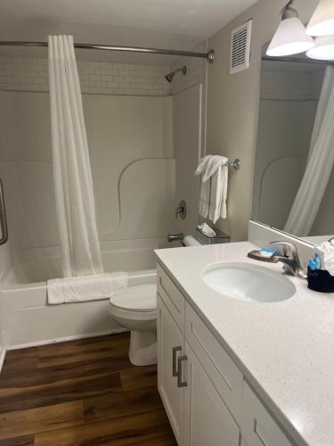 a bathroom with a sink and a toilet and a tub at Summer Sands - 207 by Sea Scape Properties in Wrightsville Beach