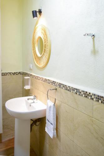 a bathroom with a sink and a mirror at Casa Ana, Flores Island in Flores
