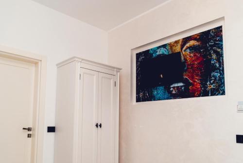 a painting hanging on a wall in a room at Casa Del Sole in Alba Iulia