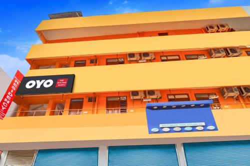 a building with an ovo sign on the side of it at Hotel O Classic Grand Residency in Puducherry