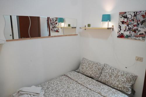 a small room with a couch and a mirror at Vatican R(h)ome in Rome
