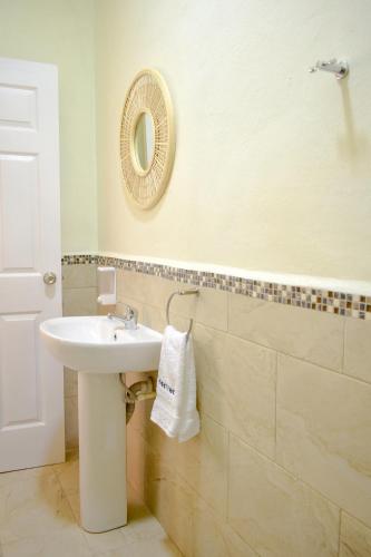 a bathroom with a sink and a mirror on the wall at Casa Ana, Flores Island in Flores