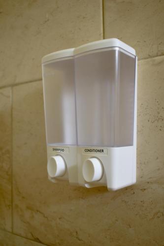 a soap dispenser hanging on a wall at Casa Ana, Flores Island in Flores