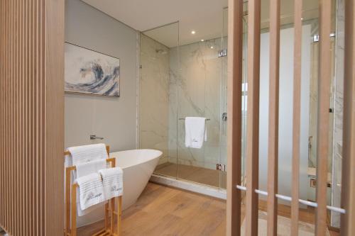 a bathroom with a bath tub and a shower at When Away - Your Home Away from Home in Pretoria