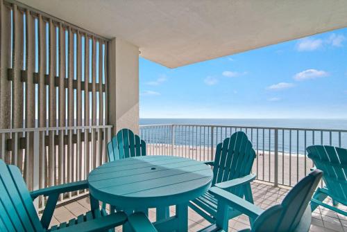 a table and chairs on a balcony with the beach at Shoalwater 705- Beach front indoor pool hot tub grill in Orange Beach