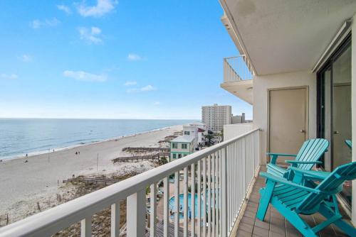 a balcony with two chairs and the beach at Shoalwater 705- Beach front indoor pool hot tub grill in Orange Beach