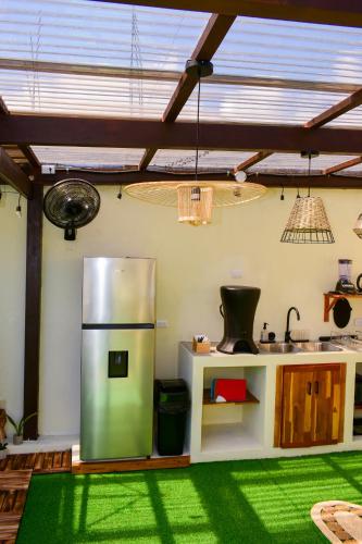 a kitchen with a stainless steel refrigerator in a room at Casa Ana, Flores Island in Flores