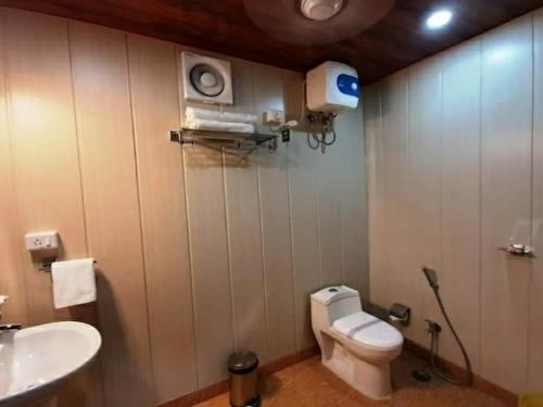 a bathroom with a white toilet and a sink at Hotel Arcadia plutus in Jaipur
