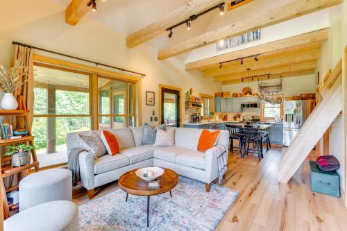 a living room with a couch and a table at Fire Pit and Views Pet-Friendly Vermont Cabin in Craftsbury